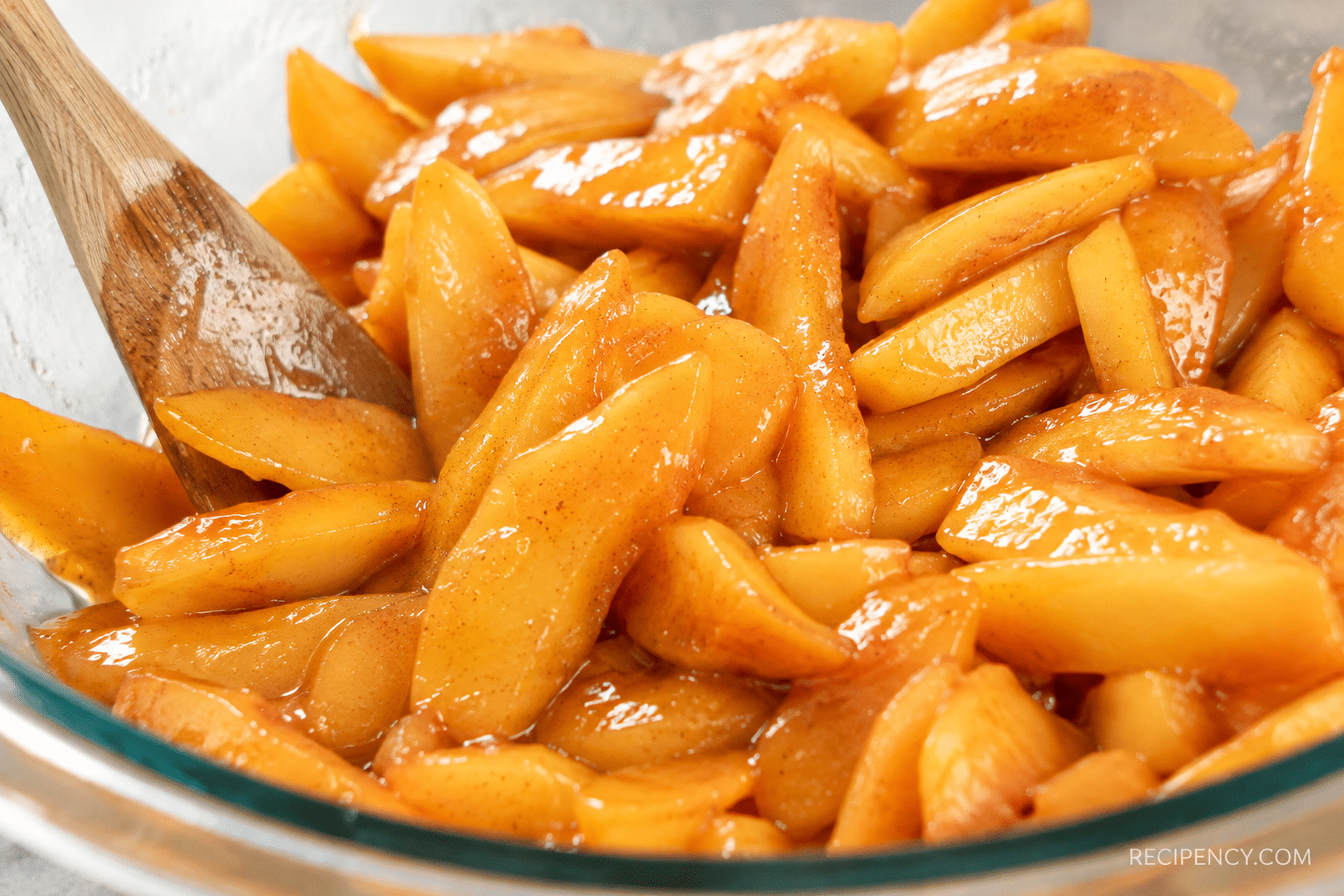 Fresh peach slices coated with sugar, cinnamon, nutmeg, lemon juice, and cornstarch