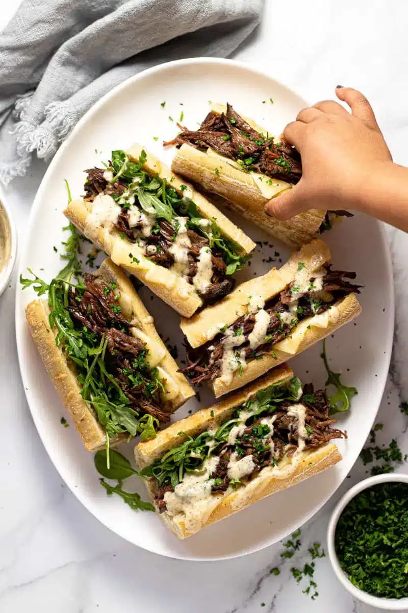 Easy Instant Pot French Dip 4 Platter of tender shredded beef Instant Pot French Dip sandwiches ready to serve