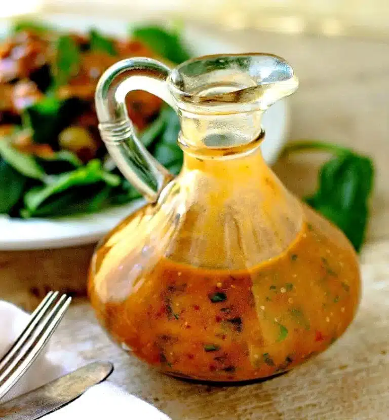 Drizzling homemade Tomato Basil Vinaigrette over a fresh green salad