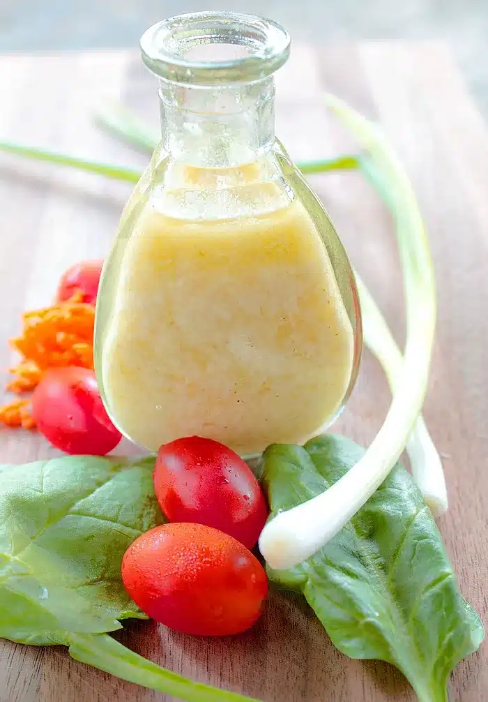 Creamy Parmesan Vinaigrette with shaved parmesan cheese on top
